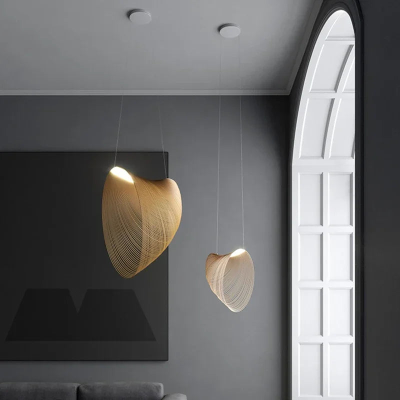LUCORA two wood-strip pendant lights, lit, by an arched window in a gray room