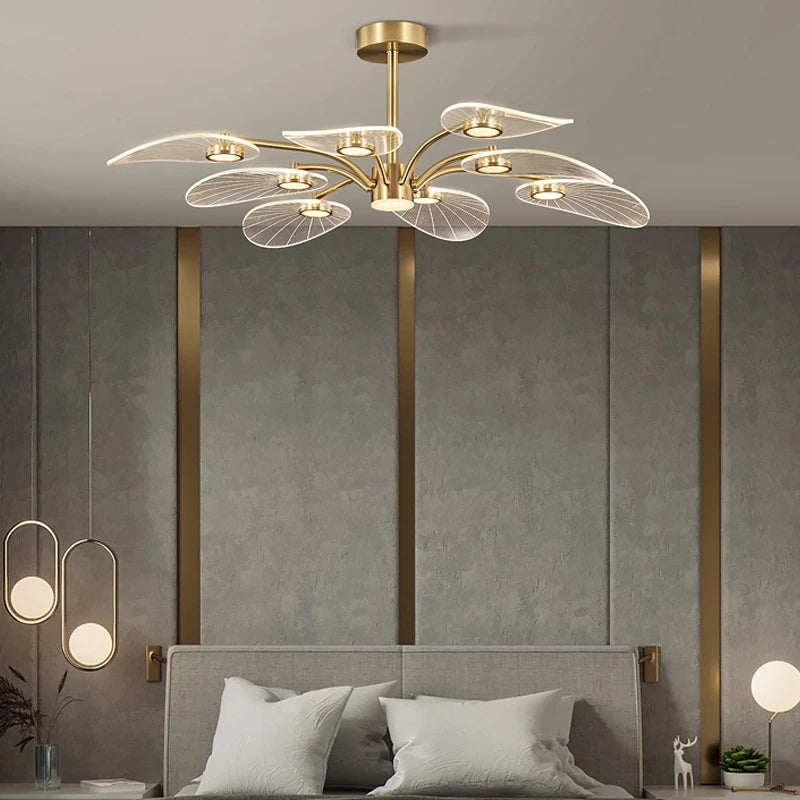 ORVIAN petal ceiling light, lit, above a bed with a gray headboard