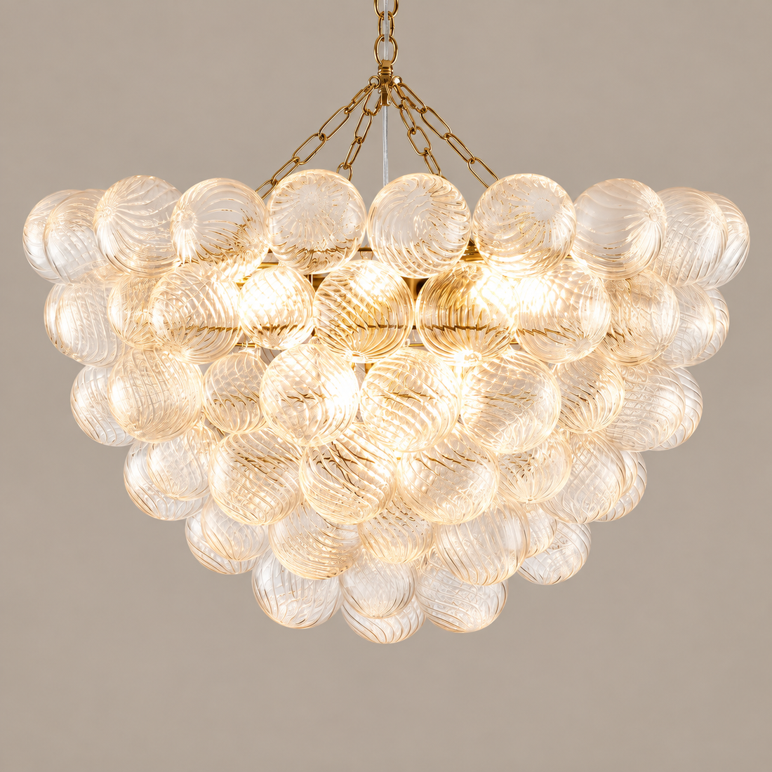 Gold ribbed glass bubble chandelier on a mushroom taupe background