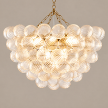 Gold ribbed glass bubble chandelier on a mushroom taupe background